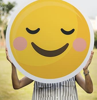 person-holding-yellow-smiley-round-plate-thumbnail