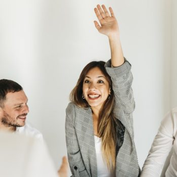 enthusiastic-young-woman-with-raised-hand_23-2148222545